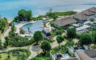 Gardens surround the buildings and pools of this beach-side resort.